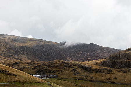 brown mountain near houses thumbnail