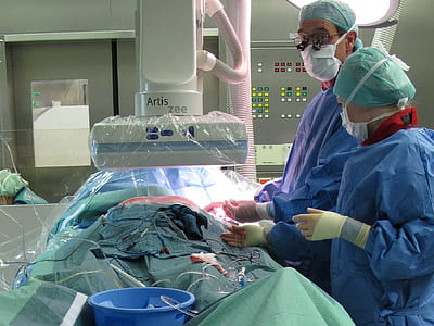 two doctors standing operating patient inside hospital thumbnail