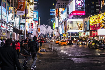 group of people walking along highway during night time thumbnail