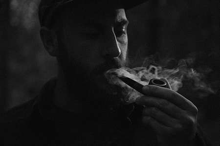 man smoking on tobacco pipe thumbnail