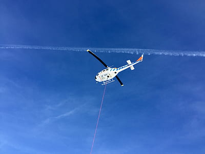 white helicopter on air at daytime thumbnail