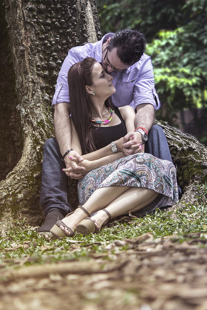 man sitting hugging woman
