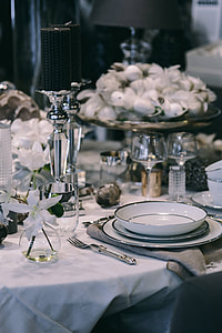 Fancy restaurant dinner table decorated with quail eggs and feathers thumbnail