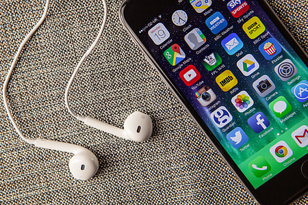 Close up shot of the mobile iPhone 6 smartphone and Apple earphones thumbnail