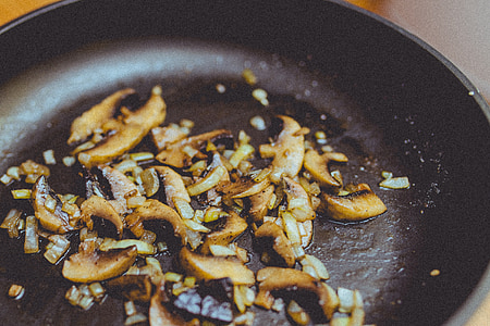 mushrooms and garlics on pan thumbnail