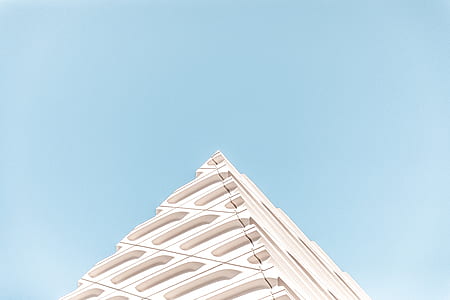 low angle photo of white building under blue sky thumbnail