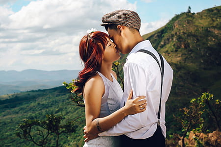 man and woman kissing and view of mountain thumbnail