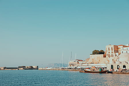 boat on body of water near city building thumbnail