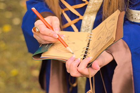 woman holding orange pencil thumbnail
