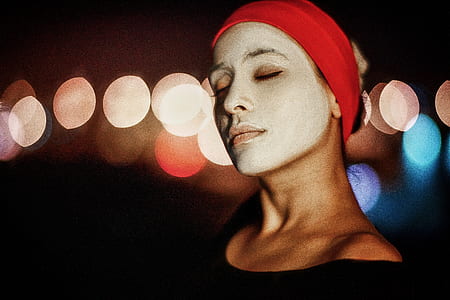 bokeh photography of woman wearing white facial mask thumbnail
