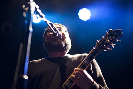 man singing on stage at the concert thumbnail