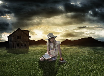 girl wearing white and purple cap-sleeved dress sitting on green grass while reading book under cloudy sky thumbnail