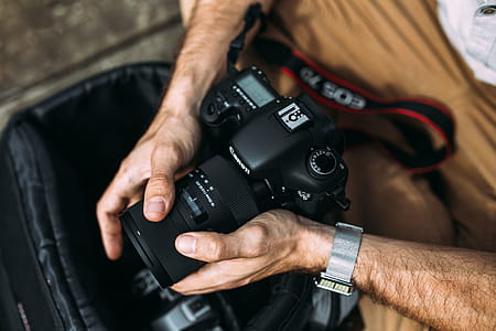 Photographer holding a DSLR camera thumbnail