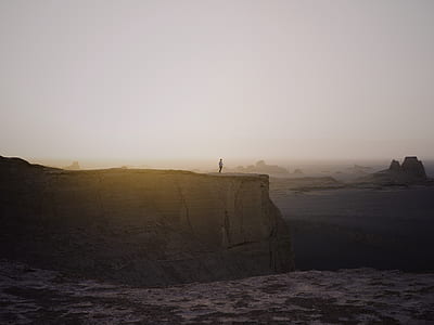 man standing on mountain edge thumbnail