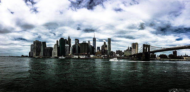 cityscape beside body of water under white cloudy sky at daytime thumbnail