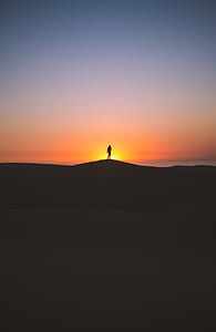 silhouette of person on top of mountain during sunset thumbnail
