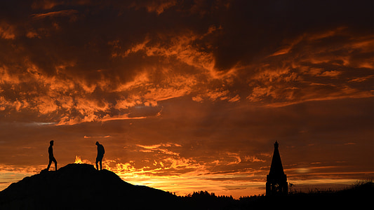 silhouette of two person on hill thumbnail