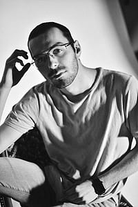 grayscale photography of man wearing crew-neck shirt thumbnail