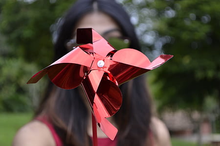 woman wearing sunglasses holding red propeller thumbnail