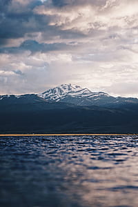 landscape photo of glacier mountain below white sky thumbnail