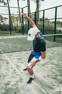 man standing near tennis net thumbnail
