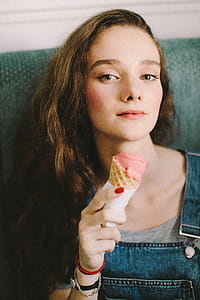 Woman Holding Strawberry Flavored Ice Cream thumbnail