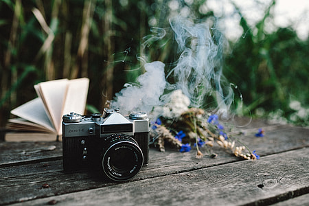 Colorful smoke bomb, book and vintage camera thumbnail