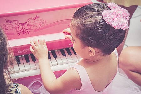 girl playing pink piano toy thumbnail