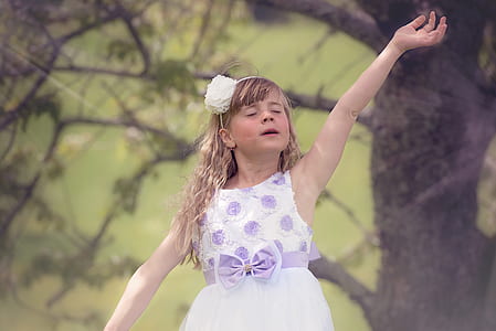 close up photography of girl stands near tree thumbnail