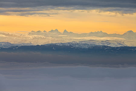 landscape photography of mountain range under white sky thumbnail