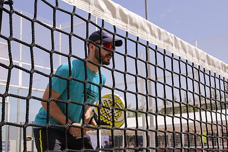 man playing tennis during daytime thumbnail