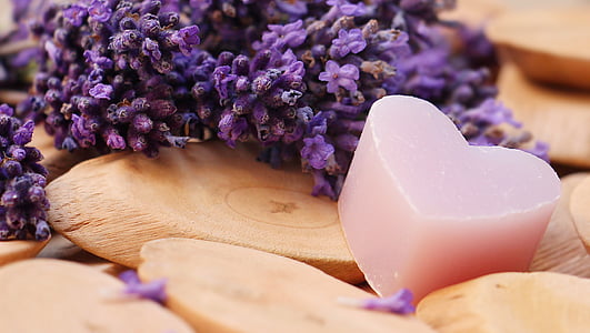 depth of field photography of pink heart soap beside lavender flowers thumbnail