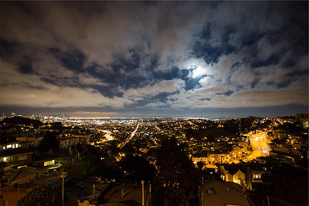 aerial view of city under cloudy sky thumbnail
