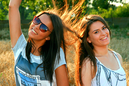 two woman standing side-by-side thumbnail