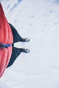 person standing on coated snow pathway thumbnail