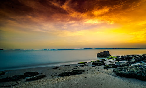 ocean under orange sky at golden hour thumbnail