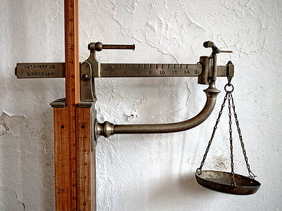 brass-colored beam balance scale mounted on wood thumbnail