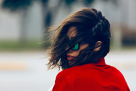 photography of woman wearing sunglasses and red top during daytime thumbnail