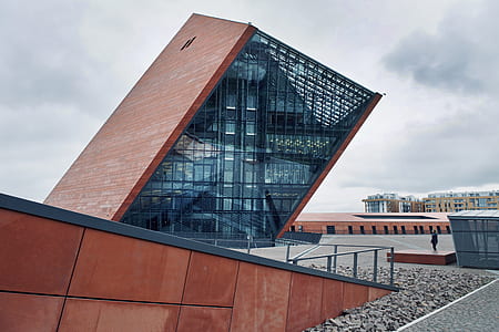brown building under cloudy sky scenery thumbnail