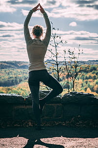 woman raising two hands watching tree thumbnail