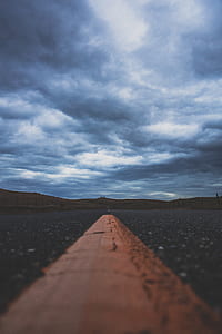 yellow road line under gray sky thumbnail