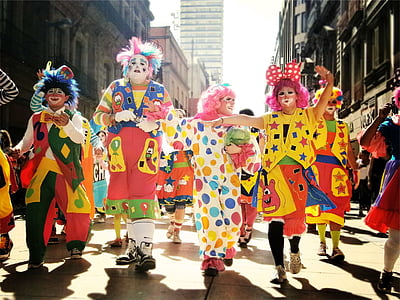 group of people dancing on street during daytime between concrete buildings thumbnail