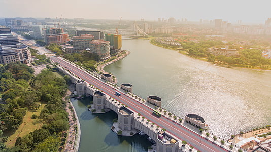concrete bridge near green trees and buildings thumbnail