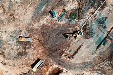 Aerial View Photography Of Utility Vehicles On Brown Soil thumbnail