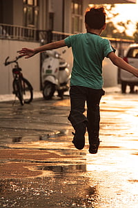 boy in green T-shirt jumping thumbnail