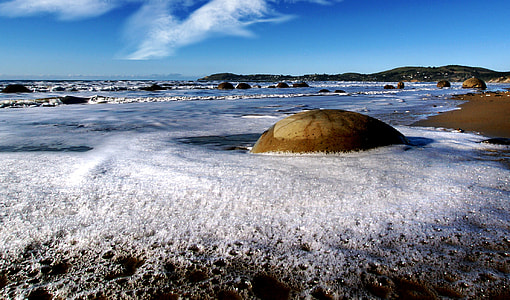 Moeraki Boulders in the surf in New Zealand thumbnail