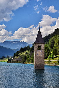 gray concrete tower on body of water thumbnail