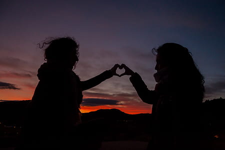 silhouette of two person forming human hearts thumbnail