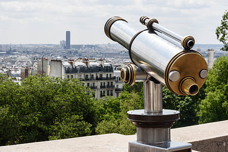 Gray and Brown Tower Telescope Near Trees and High Rise Buildings thumbnail