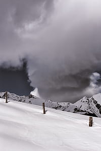 snow on top of the mountain under cloudy sky thumbnail